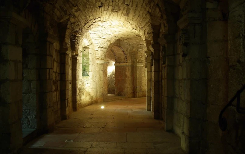 a dimly lit hallway leads into an old building