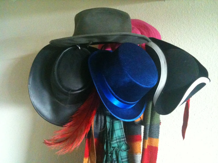 several hats, scarf and other items are arranged on the wall