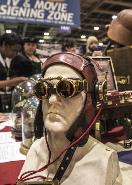 a display with a mannequin's head wearing sunglasses and a helmet with aviator goggles