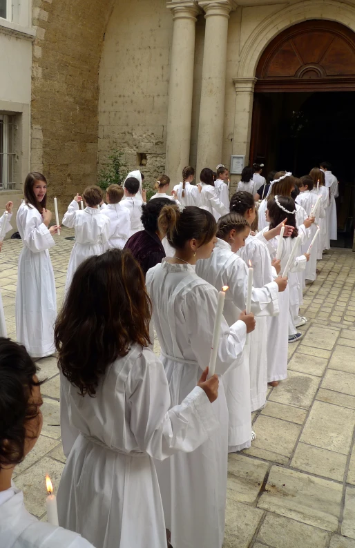 a group of people with white clothes standing together