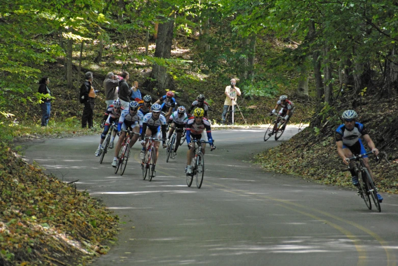 an aerial view of people riding bicycles through the woods