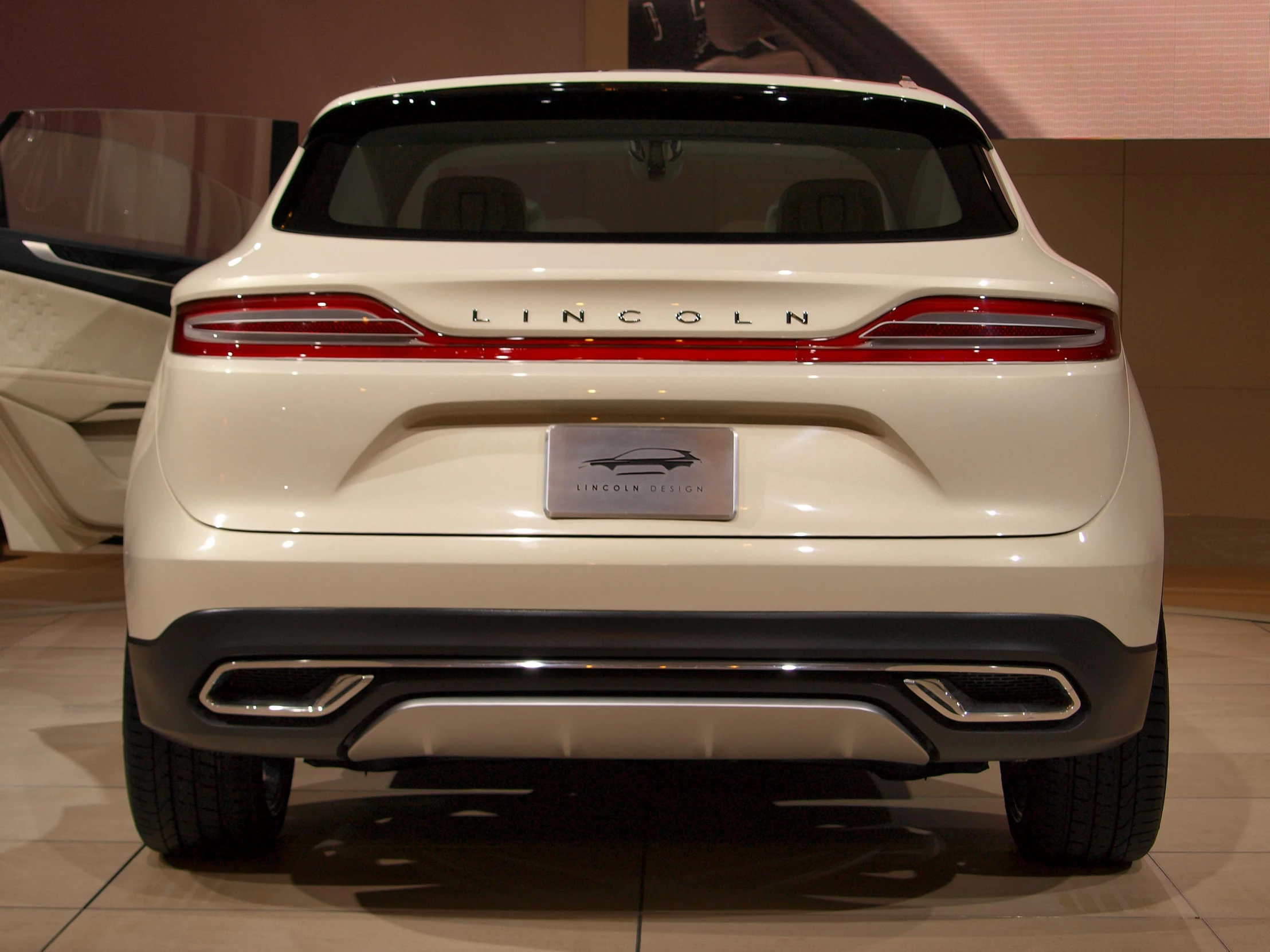 a car parked in front of a sign on display