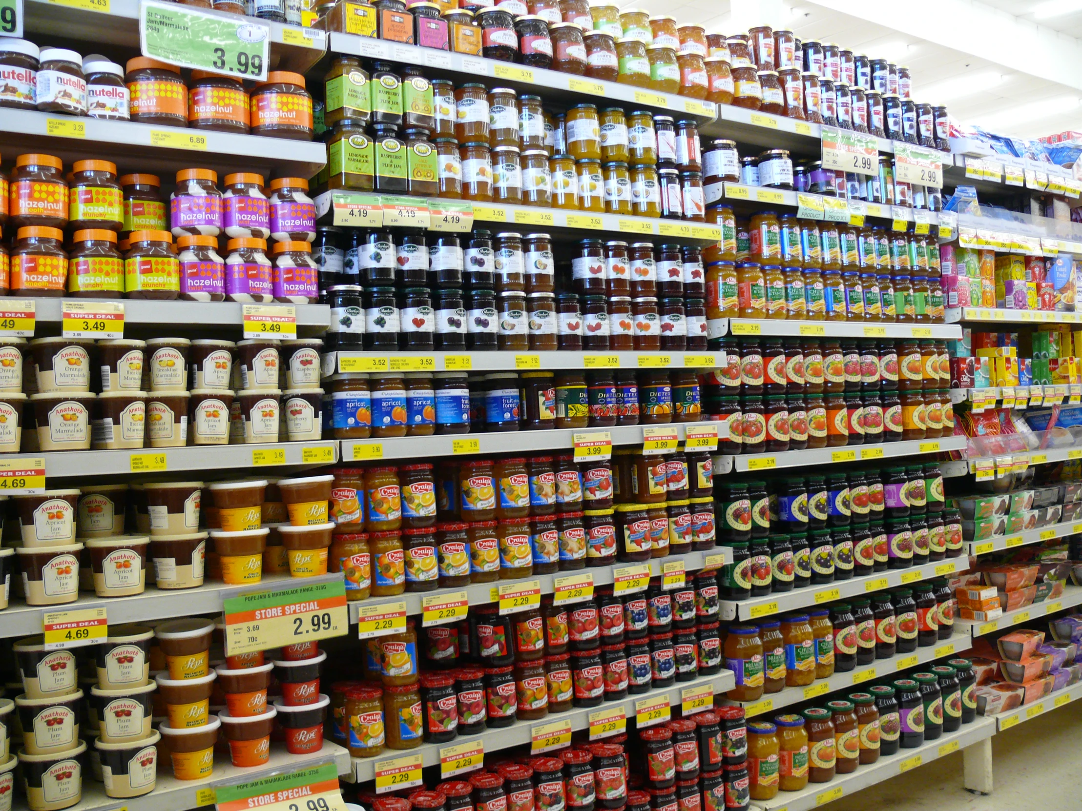 a store has shelves filled with condiments and juices