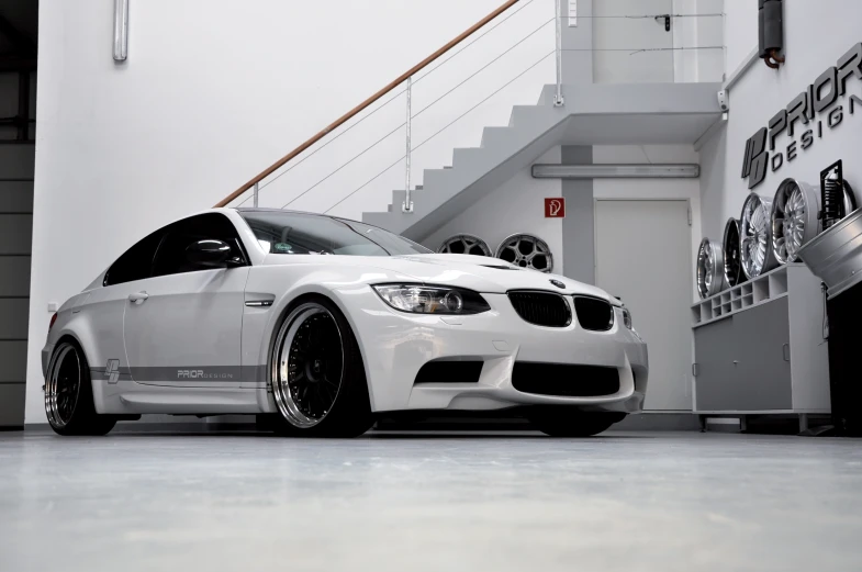 a white car parked in front of a staircase