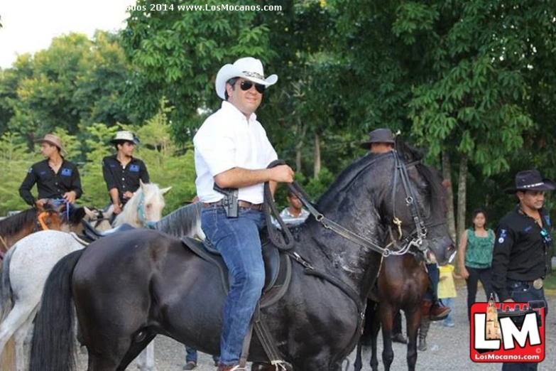 an old man on horseback with others on horses