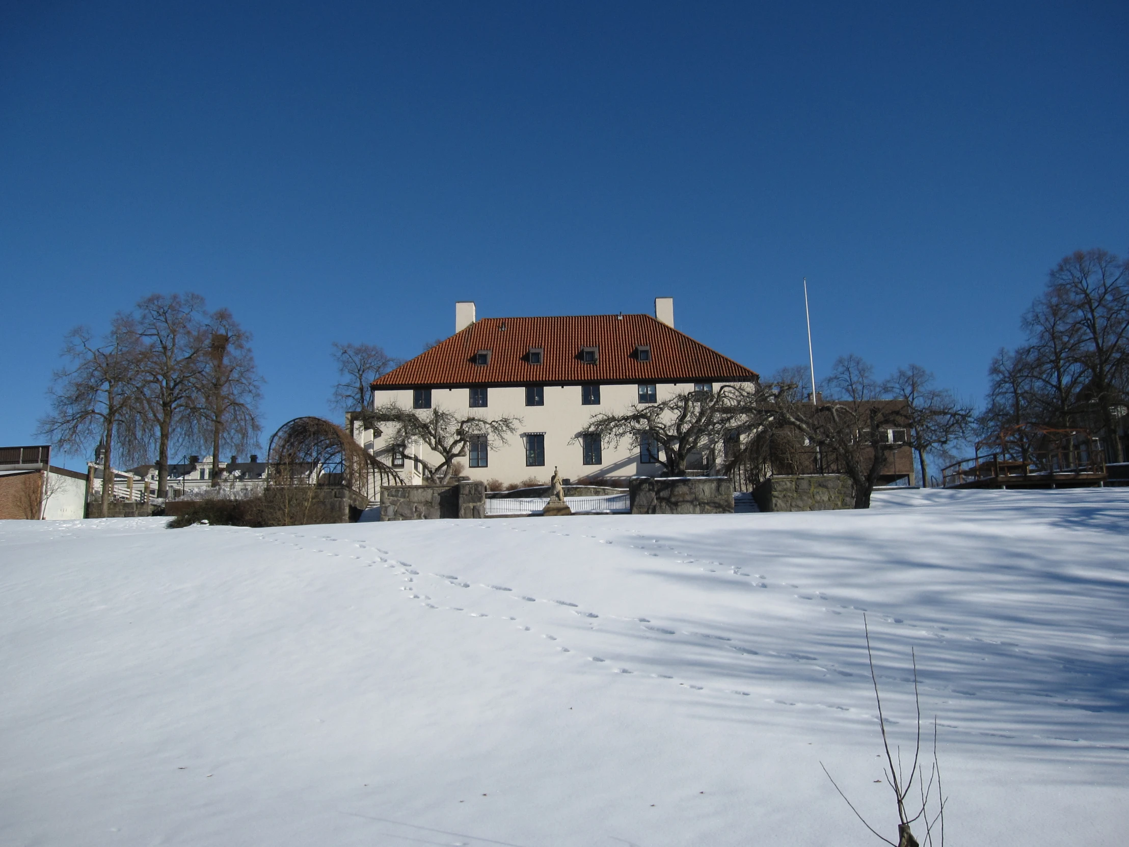 an unusual building stands in a snow - covered yard