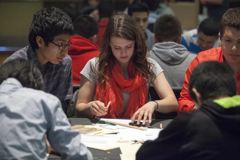 students working together in class, sitting at the desk