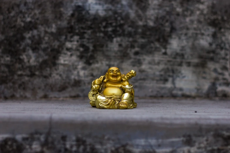 a gold statue is sitting on the ground