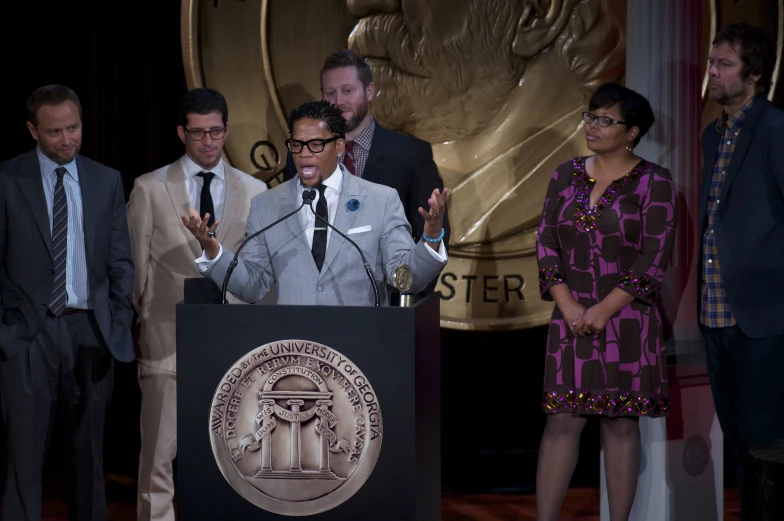 the man is speaking while standing behind the podium