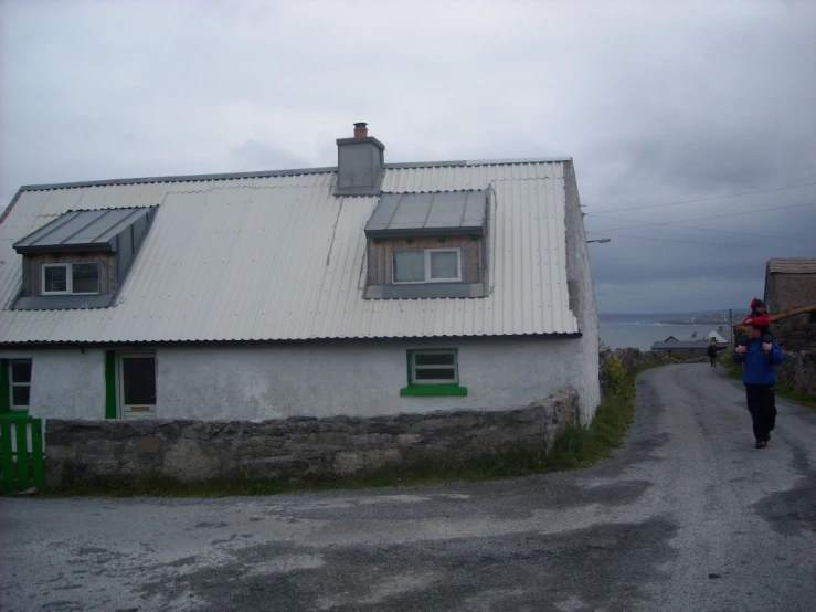 a house with a white roof and green door