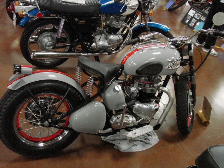a silver and black motorcycle parked inside a showroom