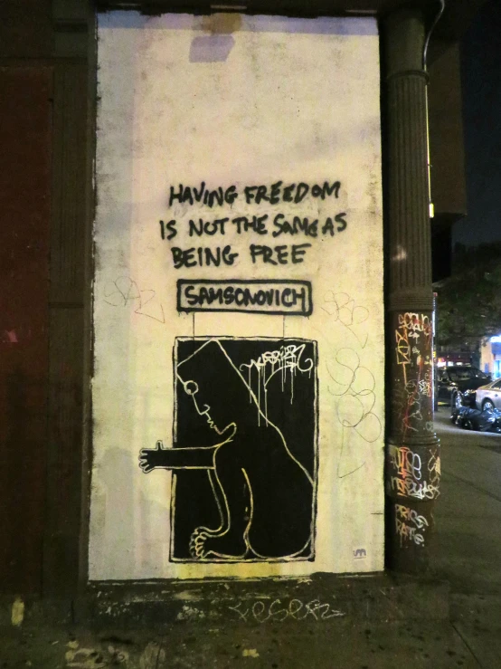 a graffitti on a white wall reads having freedom is not the santa's being free