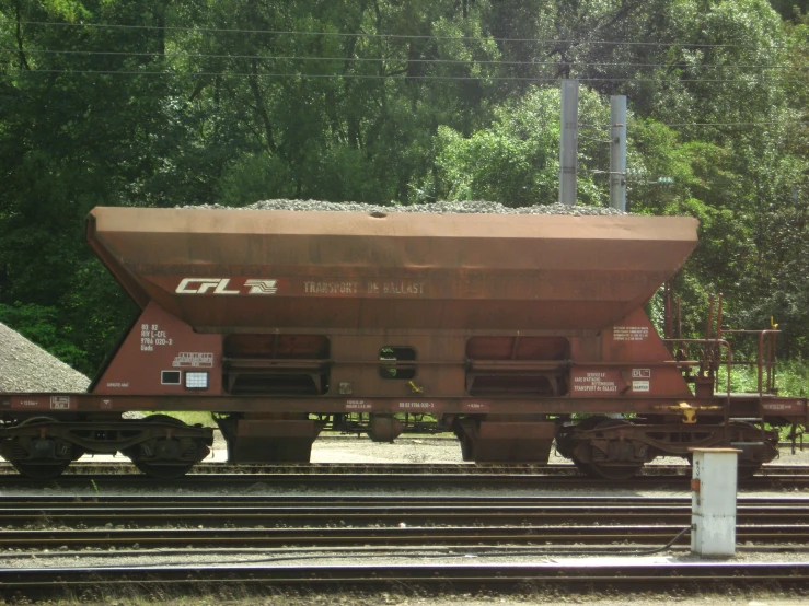 the back of an old train car sits on the tracks