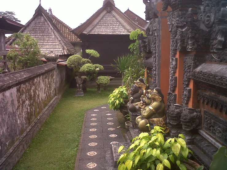 a courtyard is lined with potted plants