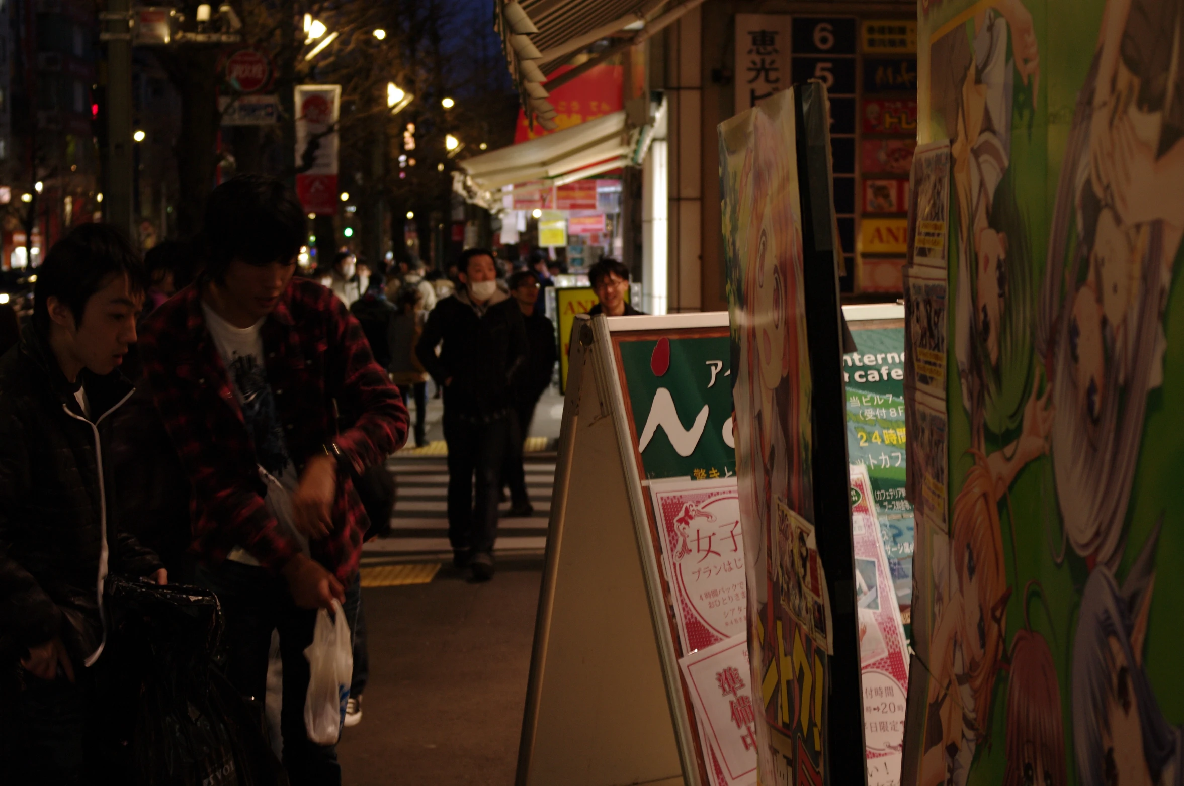 a couple walking down a sidewalk next to a store