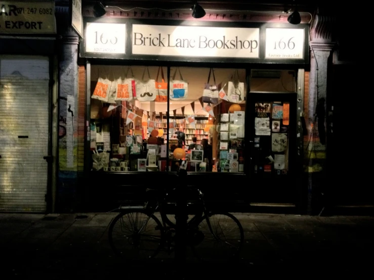 the bicycle is parked next to the store front