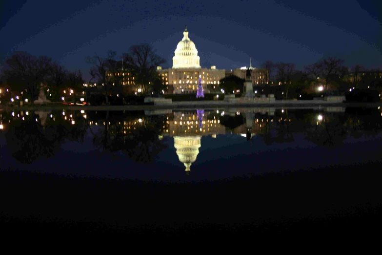 a building with the dome reflecting in the water