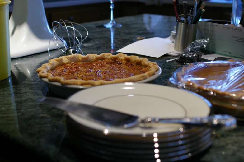 pies on plates with wine glasses and napkins