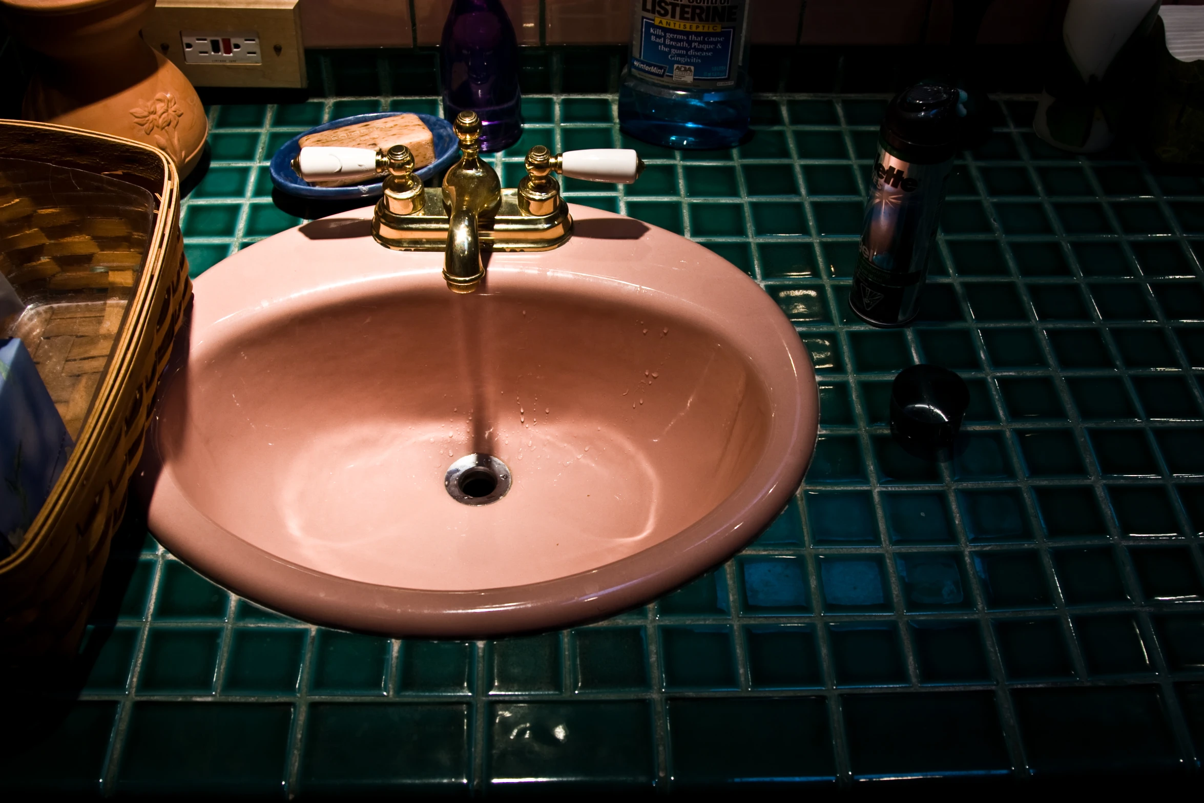 the sink has several cleaning products on it