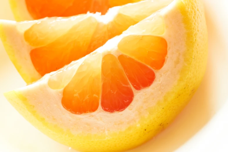 two slices of an orange are displayed on a plate