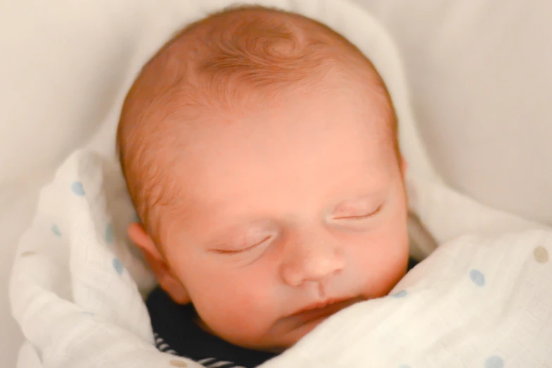 a newborn boy sleeps in his blanket with eyes closed