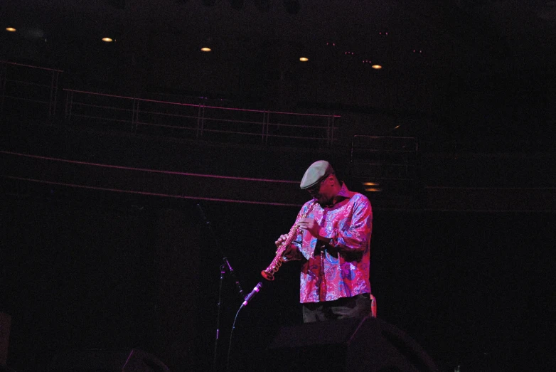 a man is standing on the stage playing a guitar
