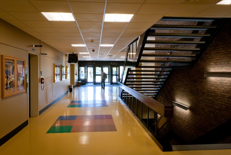 an open lobby with yellow walls and colorful carpets