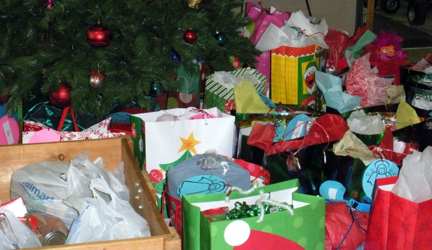 a pile of different colorful christmas gift bags