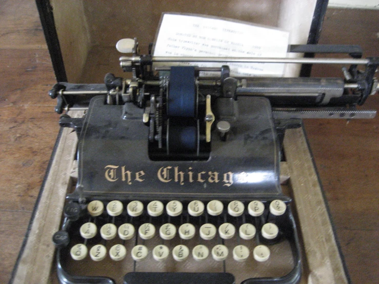 a typewriter is sitting on a stand with sheet music