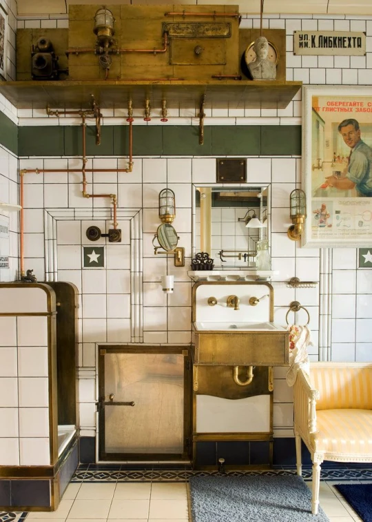 a kitchen with antique appliances on shelves, a microwave and a small desk with a chair