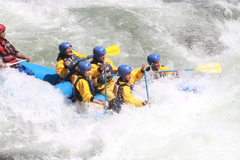 people are rafting down the rapids on the water