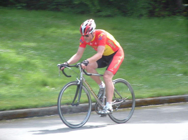 a person on a bicycle going down the street