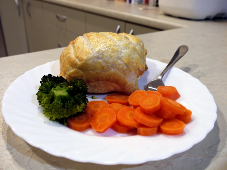 the meal includes fresh vegetables on the white plate