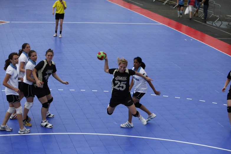 a group of people that are on a court with ball