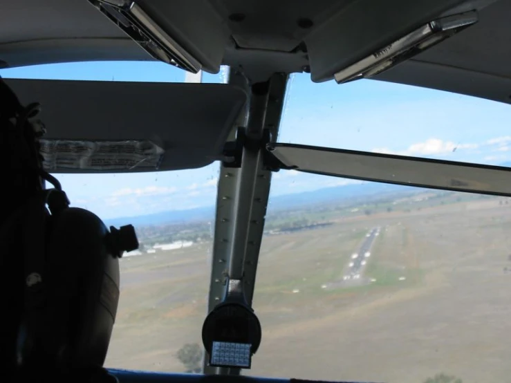 a view of the field and land from inside a helicopter