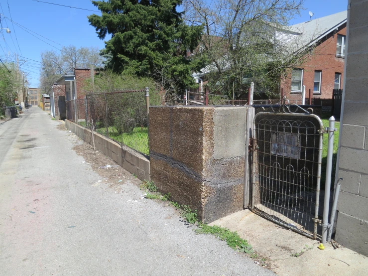 a fence along a street that is part of a housing complex