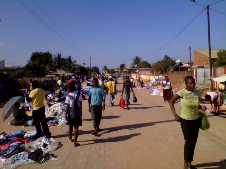 people and belongings in a crowded urban area