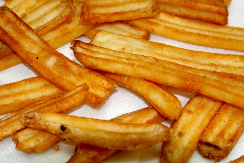 some fries are sitting on a towel on the table