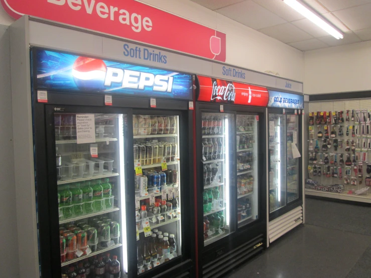 a line of soda machines for sale in a grocery store