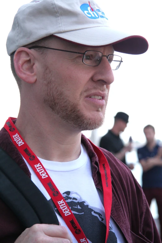 a man wearing a white cap looking away from the camera