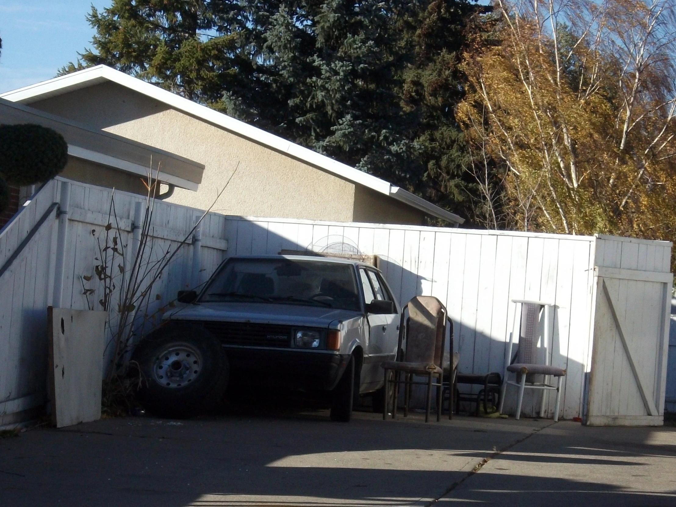 the truck is parked next to the fence