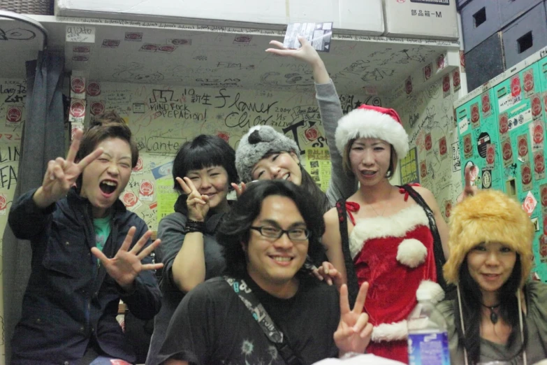 several people standing and smiling in a bathroom