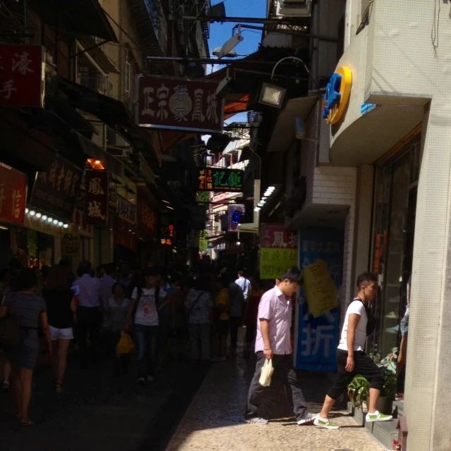 a man standing on a busy street next to a business