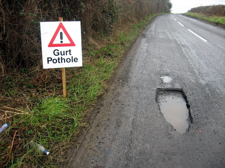 there is a pot hole on the side of the road