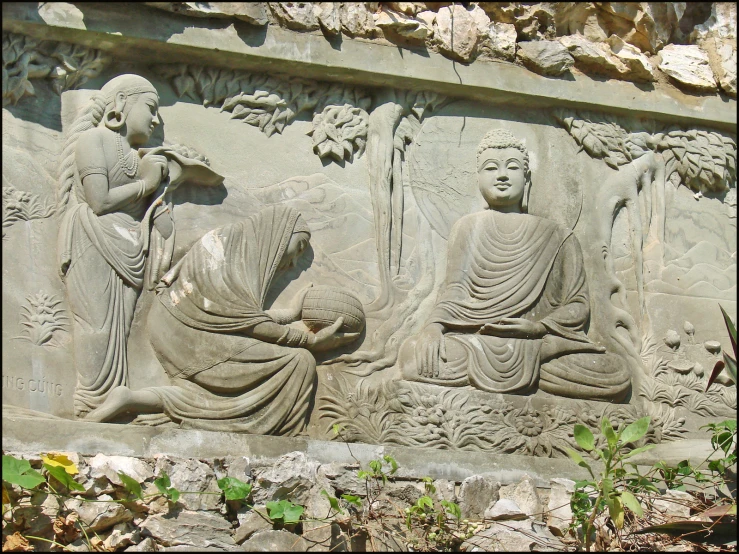 statue depicting two seated buddhas and a snake