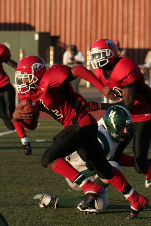 a football game with a player getting tackled