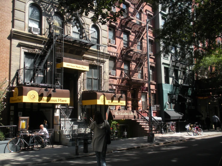 two people walking on a street near a building