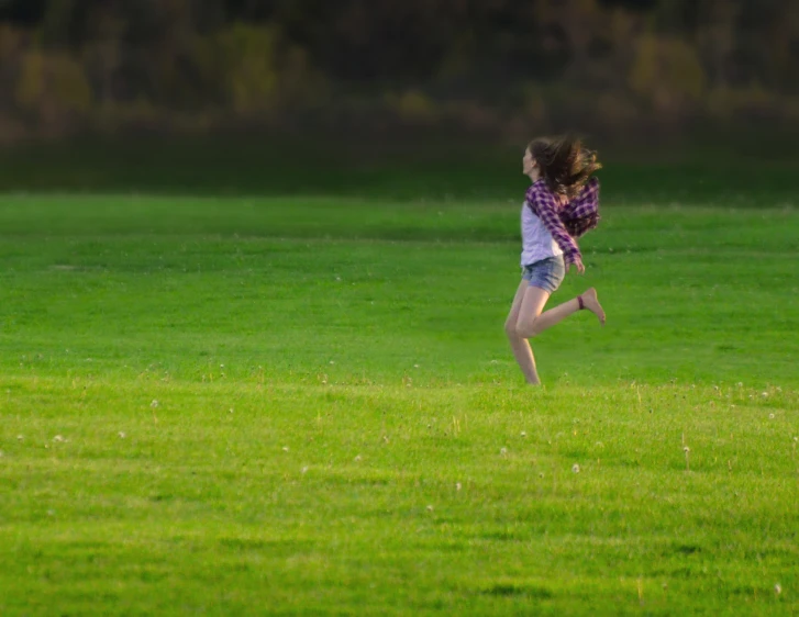 a person running through a grass field