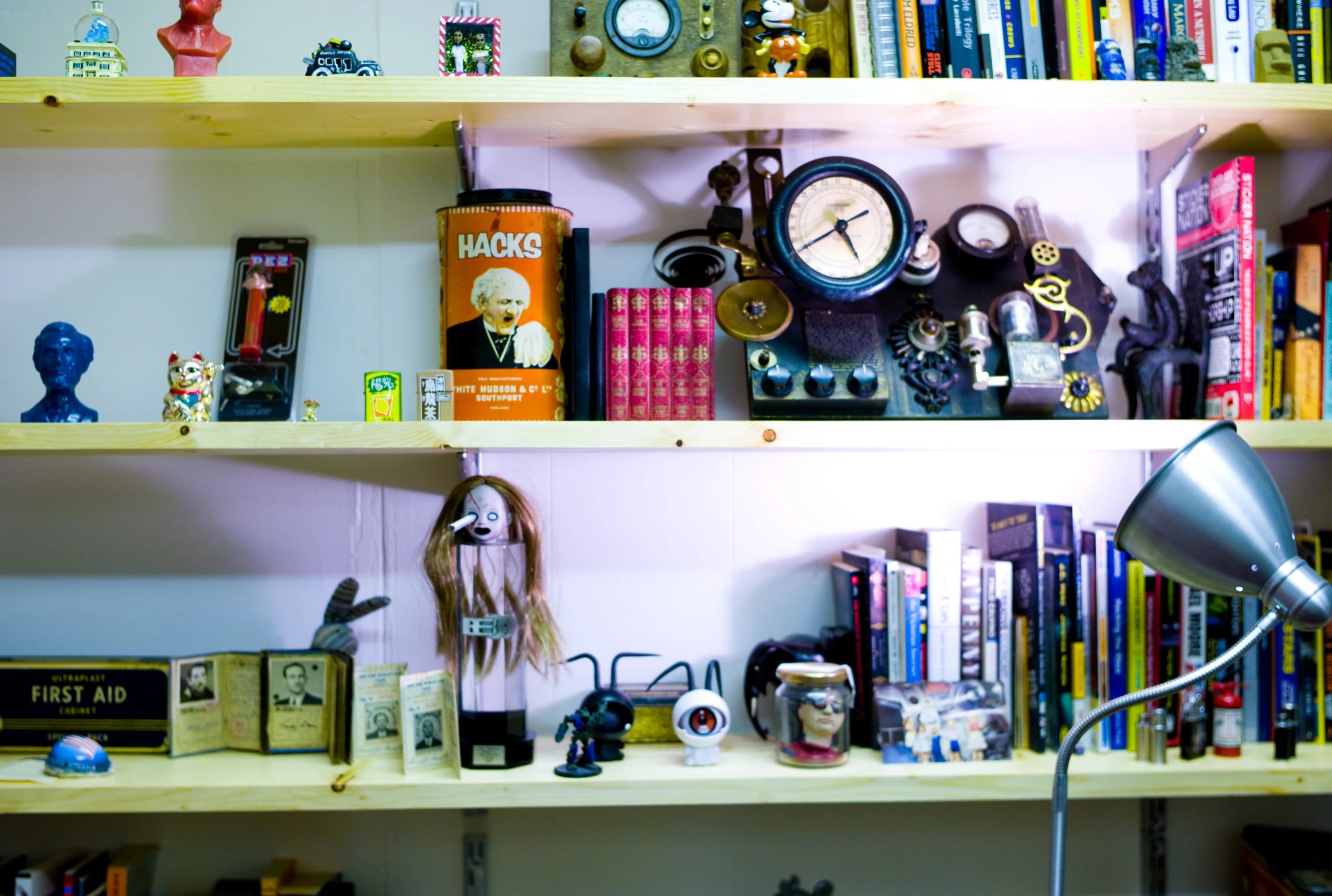 books, magazines, lamps, and other memorabilia are on the shelves