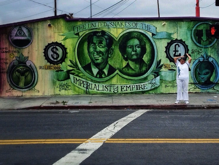 a man that is standing in front of a wall